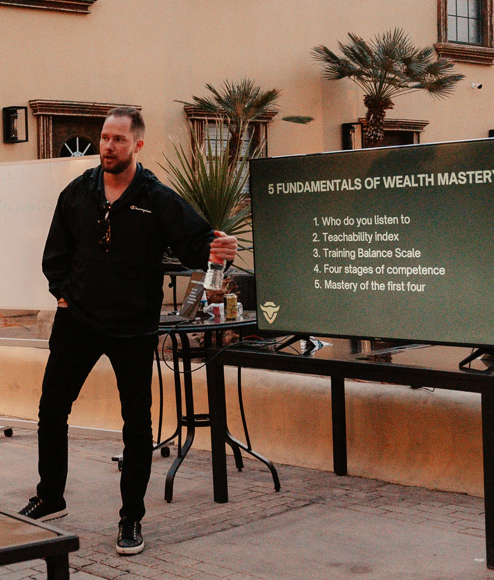 Nick teaching the 5 fundamentals of wealth mastery live on stage